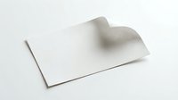 White blank business card with curved corner lifted up showing shadow and depth on clean background for corporate branding mockup.