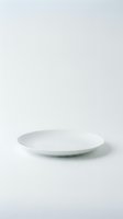 Empty white ceramic plate on neutral background for product photography and food presentation mockups.