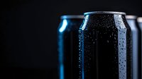 Cold aluminum beverage can with water drops and condensation against dark background, dramatic side lighting creates glossy reflective surface.