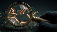 Magnifying glass examining glowing circuit board patterns with orange light traces. Digital forensics and cybersecurity investigation concept for technology analysis.