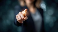 Businesswoman pointing finger at virtual screen, concept of digital technology selection and modern business interaction.