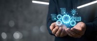 Businessman holding glowing digital technology icons and data symbols in cupped hands representing innovation, connectivity and digital transformation solutions.