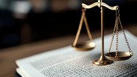 Vintage brass scales of justice on open law book with dramatic lighting, symbolizing legal system, jurisprudence and court proceedings. Suitable for legal articles.