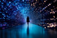 Silhouette of woman standing in futuristic digital tunnel with glowing blue particles and light effects creating magical atmosphere. Concept of technology and future.