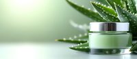 Luxury cosmetic cream jar with fresh aloe vera leaves on green background, natural skincare product for spa and beauty treatments, wellness concept.
