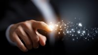 Businessman finger touching glowing network connection point with sparkling light effect against dark background, representing digital transformation.