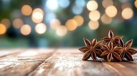 Star anise pods arranged on rustic wooden surface with soft bokeh lights in background creating magical holiday atmosphere and warm festive mood.