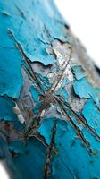 Peeling turquoise paint with exposed wood and rust texture, showing weathered decay and deterioration on aged surface for design and background use.
