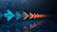 Digital arrows in blue and orange gradient colors moving forward on dark technology background with binary code pattern, representing data flow and progress.