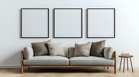 Modern living room interior with beige sofa, brown cushions, wooden side table and three empty black frames on white wall. Minimalist home decor setup.