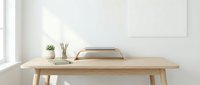 Minimalist home office workspace with wooden desk, laptop stand, pencils, succulent plant, and blank frame on white wall.