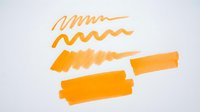 Assorted orange marker strokes and brush marks on white background, isolated design elements for graphic projects, presentations, and creative layouts.