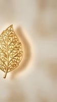 Elegant golden leaf with intricate filigree pattern on warm beige background for luxury design projects and decorative applications.