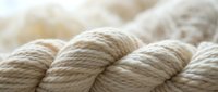 Natural beige rope coils with twisted fiber texture for nautical crafts and marine applications.