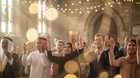 Diverse multiethnic group of people raising hands in a sunlit cathedral, celebrating unity, faith, and togetherness in a spiritual gathering.