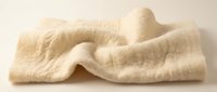 Folded beige linen fabric with soft texture and natural wrinkles on neutral background for textile, fashion, and interior design projects.