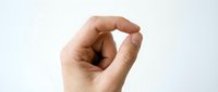 Caucasian male hand making small gesture with thumb and forefinger, isolated on white background for design, advertising, and educational materials.