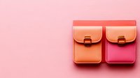 Small leather pink and coral pouches with metal clasps on pastel pink background, minimalist fashion accessories for modern lifestyle.