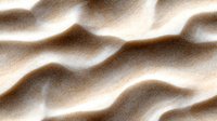 Smooth flowing waves of beige and brown silk fabric create elegant abstract pattern with soft shadows and highlights, suitable for luxury design backgrounds.