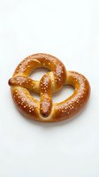 Fresh baked soft pretzel with coarse salt on white background isolated for food design and culinary projects.