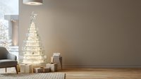 Minimalist holiday decor with illuminated tree wall decal, wrapped gifts, and calendar displaying 2027 in modern living room interior.