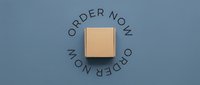 Cardboard box centered on blue background with circular order now text, e-commerce shipping and delivery concept for online retail marketing.