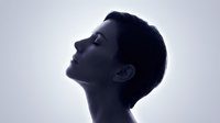 Young man in profile silhouette looking up with peaceful expression against soft gradient background for wellness and mindfulness concepts.
