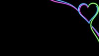 Neon heart shape with glowing rainbow colors on black background for romantic designs and love-themed projects.