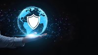 Businessman hand holding glowing digital globe with security shield icon representing global cybersecurity and data protection technology solutions.