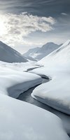 Winding stream cutting through snow-covered mountain valley with dramatic clouds above, creating serene winter landscape with pristine white slopes and flowing water.