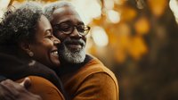 Senior African American couple embracing outdoors with warm autumn background, showcasing love and connection in their golden years.