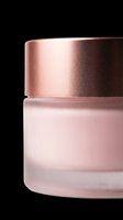 Cosmetic jar with rose gold metallic lid and frosted pink glass container, isolated on transparent background, ready for beauty product packaging design, skincare branding, and print-on-demand applications.