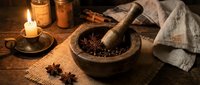 Rustic wooden mortar and pestle with aromatic spices on burlap cloth, candlelight creating warm atmosphere for cooking and herbal preparation concepts.
