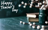 Teacher's Day celebration concept with white cotton stems in blue jar, stacked books against dark green chalkboard background with festive greeting.