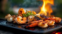 Grilled jumbo shrimp with herbs and spices cooking on hot barbecue grill with dramatic flames, close up view of seafood preparation in outdoor setting.
