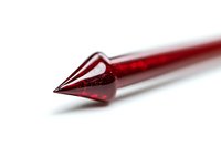 Red glass dip pen nib in macro view against white background, showing translucent crystal structure and sharp writing point for calligraphy and art.