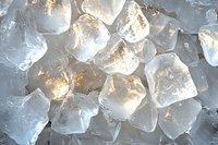 Translucent ice cubes with soft glowing light shining through creating cool refreshing texture, macro close up view for beverage and cocktail photography.