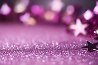 Purple glittery background with decorative stars creating magical festive atmosphere. Soft focus bokeh lights add dreamy effect for holiday designs and celebrations.