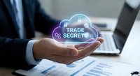 Businessman holding glowing cloud icon with trade secrets text above financial documents and laptop in modern office environment for data protection concepts.