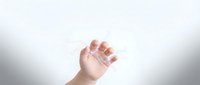 Tiny newborn baby hand with delicate fingers reaching upward against soft white background symbolizing new life, innocence and hope.