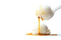 Vanilla ice cream scoops with dripping caramel sauce on white background, minimal food photography style showing sweet dessert in motion.