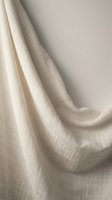 Soft beige linen fabric with natural texture and gentle folds creating elegant drapery for interior design and textile backgrounds.