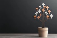 Conceptual growth tree with upward arrows in pot against dark background symbolizes business success, development and achievement in finance markets.