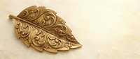 Ornate golden leaf with intricate baroque scrollwork and filigree patterns on cream textured background for luxury design projects and elegant decorations.