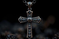Ornate silver cross pendant with blue gemstones on dark background, featuring intricate metalwork and religious symbolism, suitable for jewelry photography.