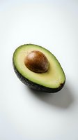 Halved avocado with pit isolated on white background, ready for food photography, culinary design, recipe blogs, and healthy eating content.
