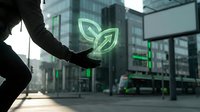 Business professional holding glowing green leaf hologram symbol representing sustainability and eco-friendly corporate solutions in modern city.