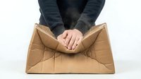 Hands holding open empty cardboard box, top view isolated on white background for packaging, delivery, and shipping concepts.