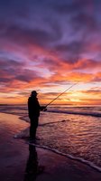 Silhouette of angler fishing at beach during dramatic sunset with purple and orange sky reflecting on ocean waves for outdoor recreation content.