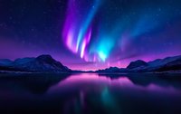 Spectacular aurora borealis dancing over mountain lake with vibrant purple and blue colors reflecting in calm water surface against starry night sky and silhouetted peaks.